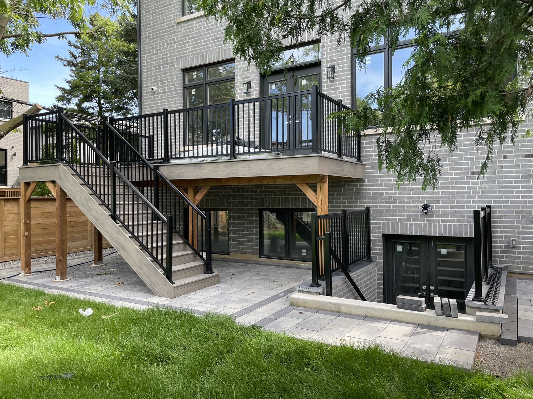 Residential backyard renovation with deck and patio